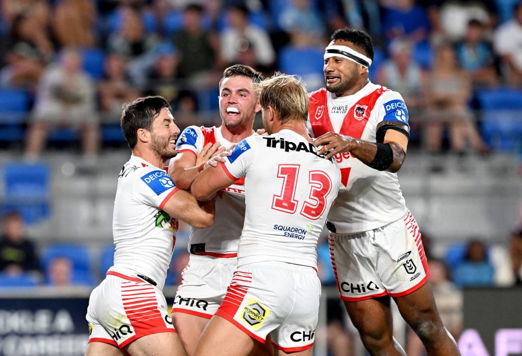 GOLD COAST, AUSTRALIA - MARCH 09: Kyle Flanagan of the Dragons celebrates with team mates after scoring a try during the round one NRL match between the Gold Coast Titans and St George Illawarra Dragons at Cbus Super Stadium, on March 09, 2024, in Gold Coast, Australia. (Photo by Bradley Kanaris/Getty Images)